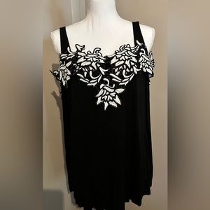 Black peek-a-boo shoulders with white floral accents along the top. Size XXL